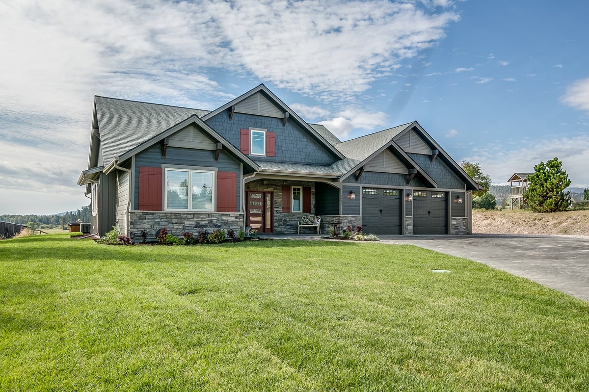 Completed new home with a two-car garage and dark exterior finish